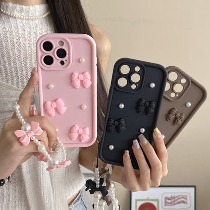 Soft Silicone 3D Bowknot Pearl Phone Case with Beaded Wrist Strap, For iPhone 17 Pro Max, For iPhone 17 Pro, For iPhone 17, For iPhone Air, For iPhone 16 Pro Max, For iPhone 16 Pro, For iPhone 16, For iPhone 15 Pro Max